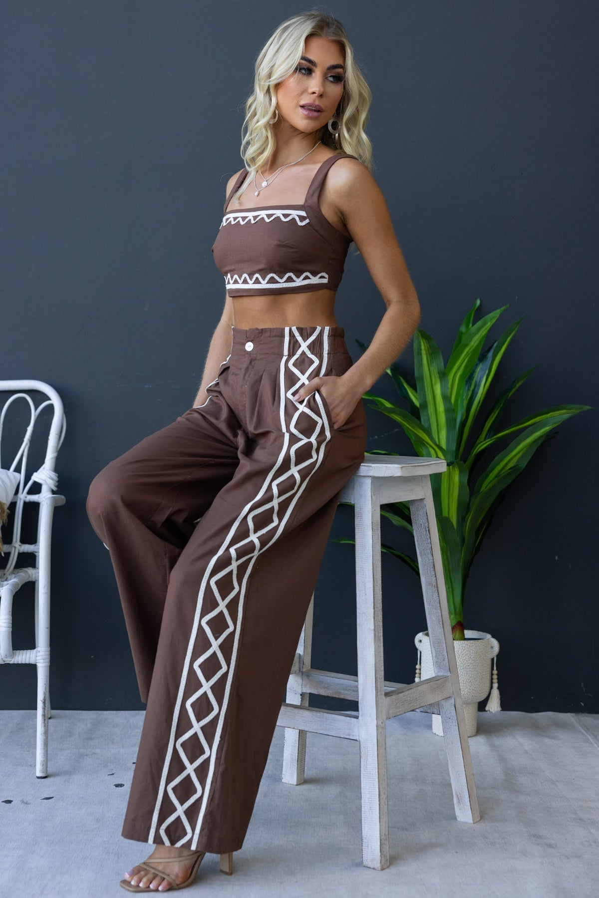 Model wearing Drisko Set featuring a square neckline crop top and wide-leg pants with decorative side details.