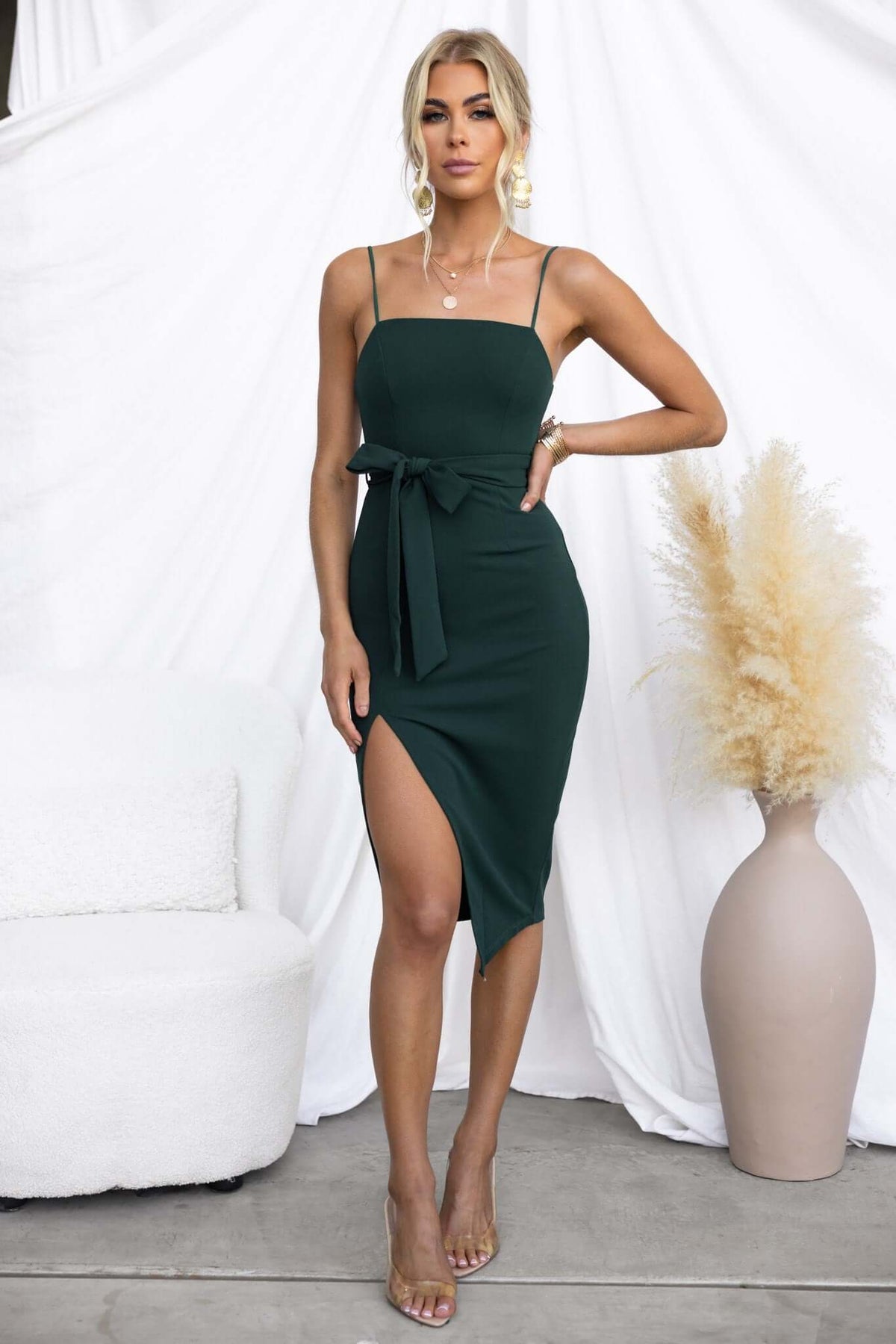 Rios Midi Dress in green featuring a square neckline, removable tie, and front split, modelled by a woman.