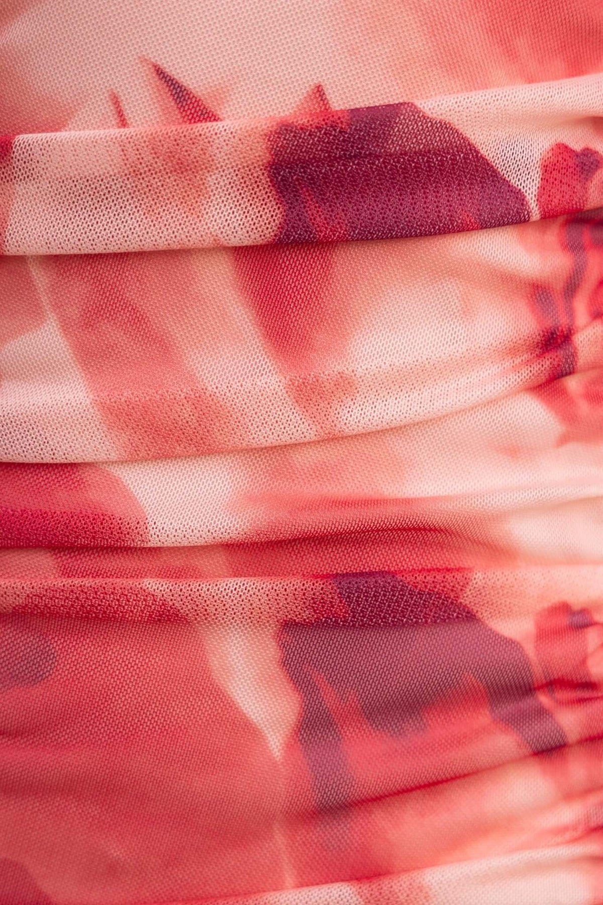 Close-up of Talinga Midi Dress fabric detail featuring a beautiful abstract floral print in red and pink hues.