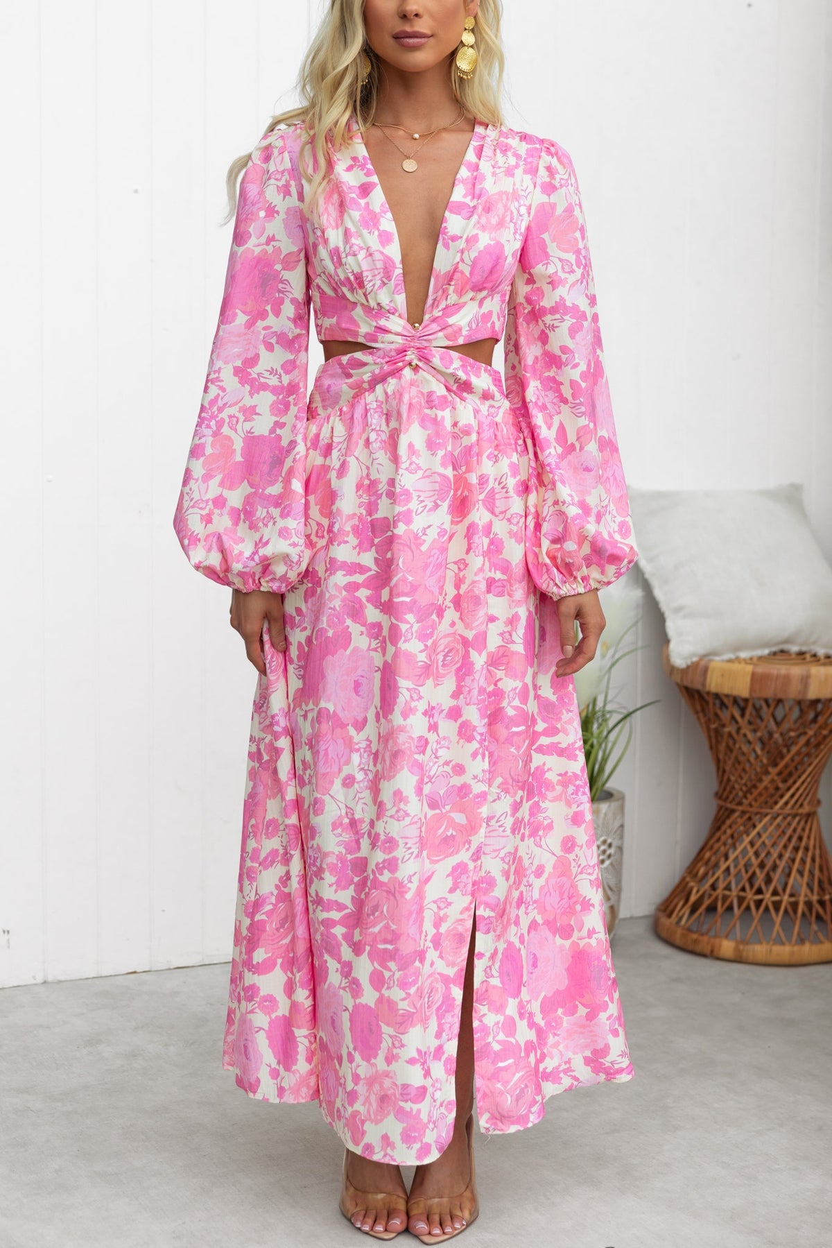 Model wearing Just Joy Maxi Dress in pink floral print with plunge neckline and cut-out waist detail.