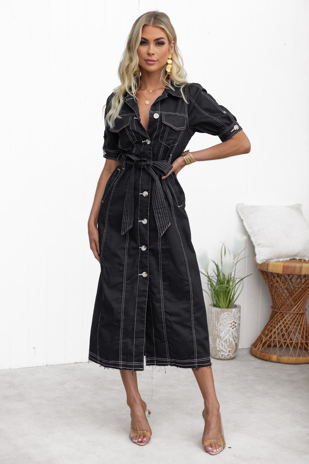 Morgan Denim Midi Dress in black with button-up front, removable belt, and frayed hemline, styled on model in bright setting.