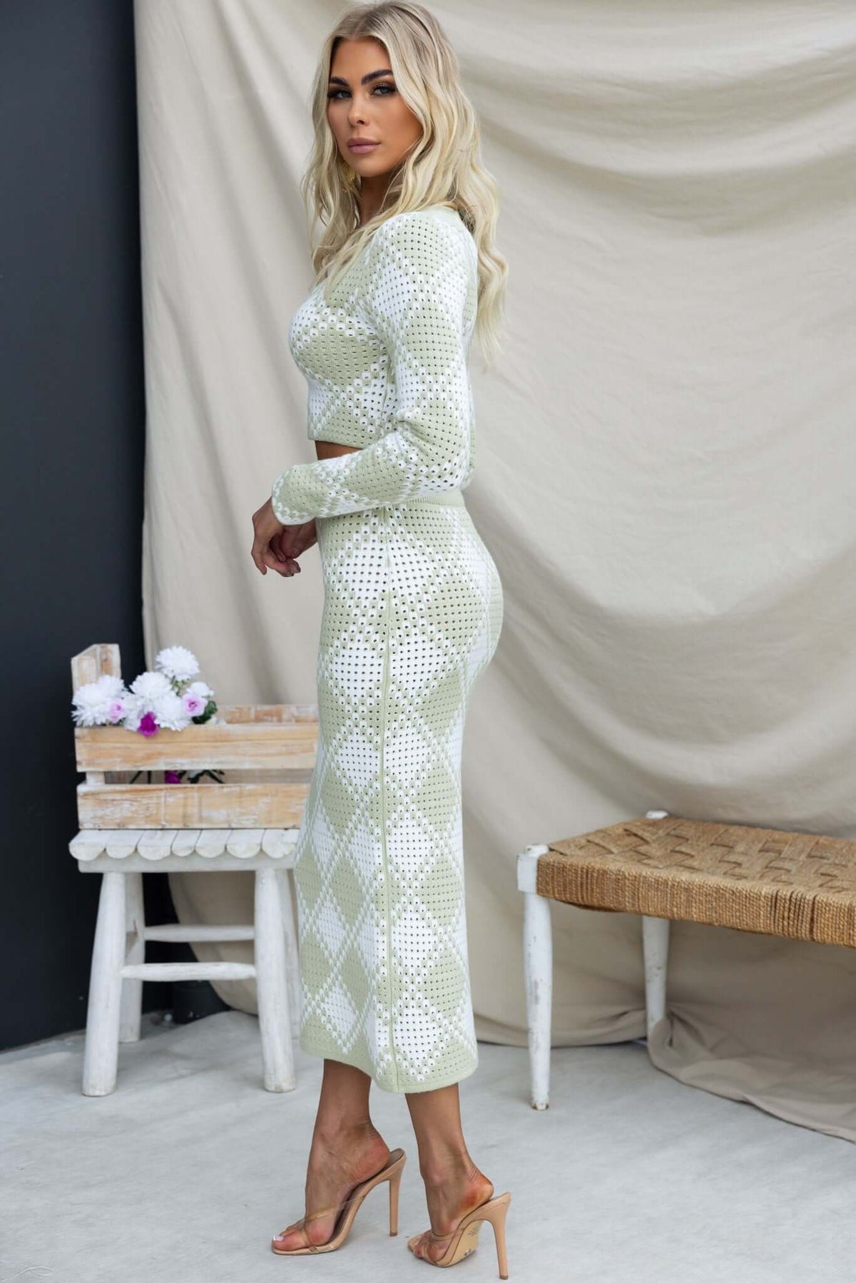 Model wearing the On My Own Set featuring a V-neckline and semi-open weave design in soft green color.