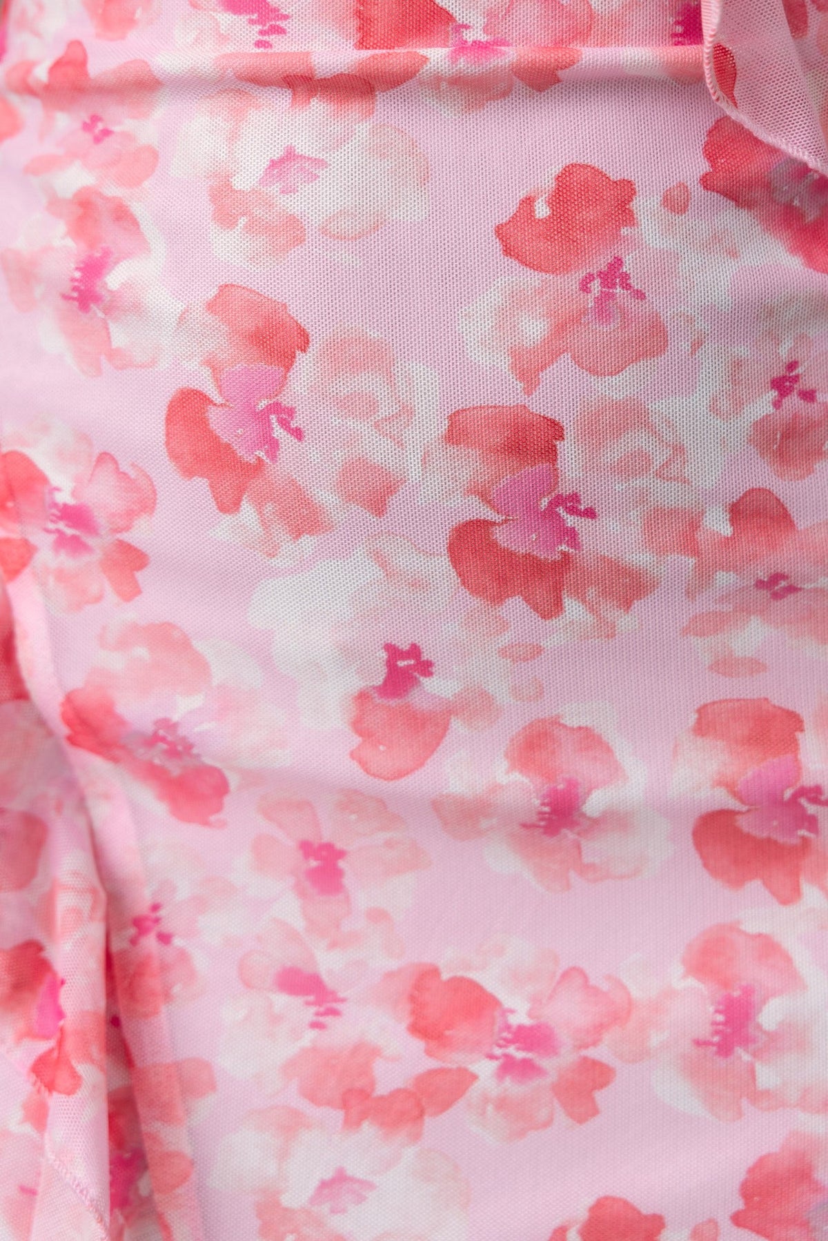 Close-up of Rarmi Maxi Dress fabric featuring a pink floral pattern with soft hues and delicate designs.