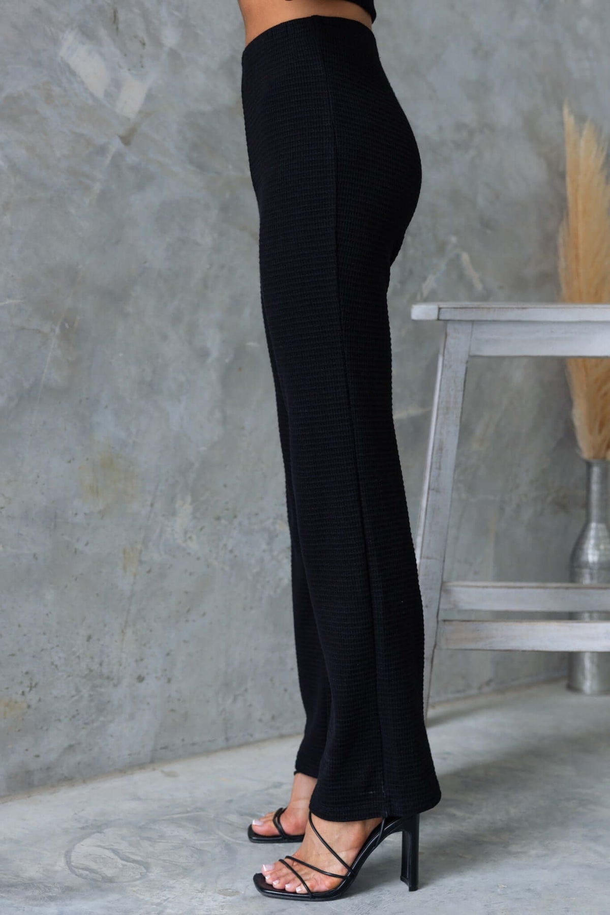 Xandra Pants in black with a mid-high waist and drop-crotch style, designed for a comfortable fit.