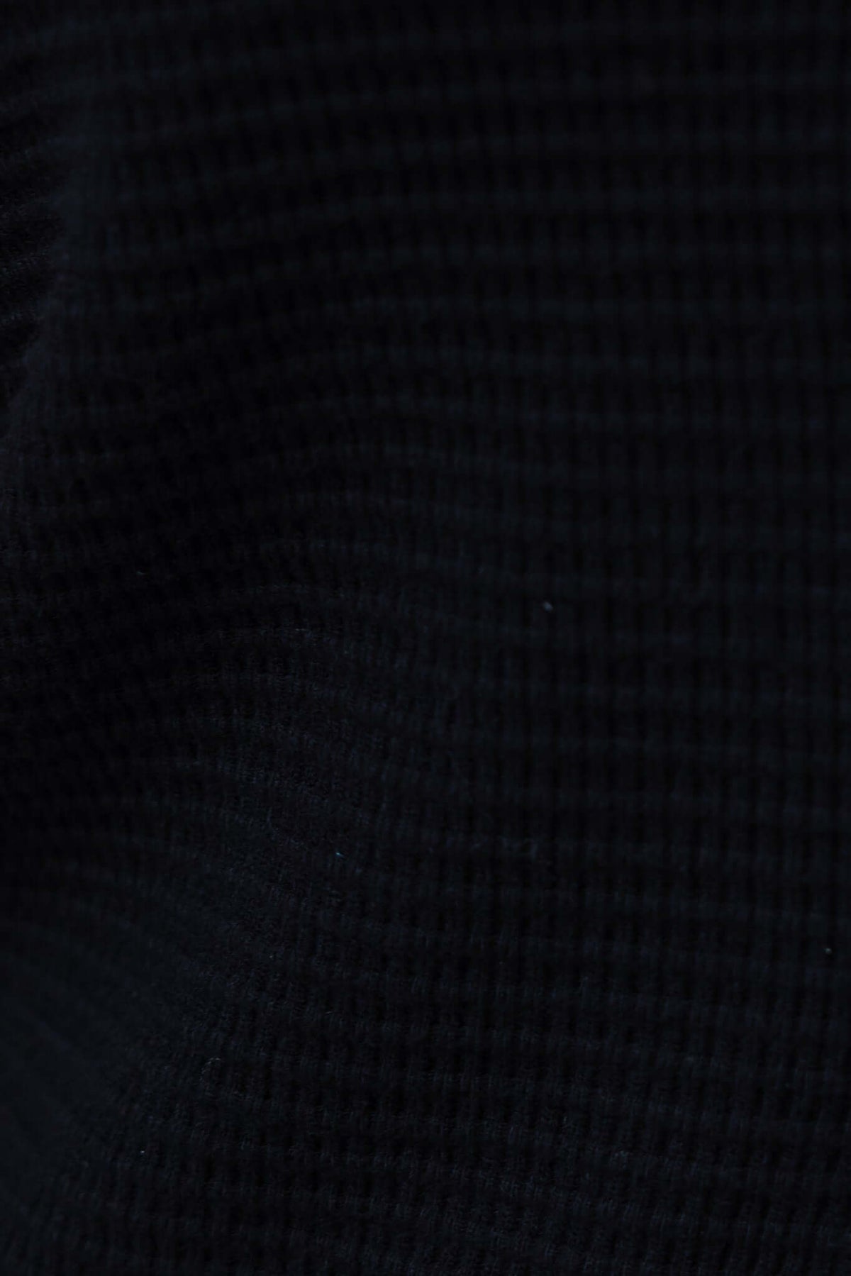 Close-up of the textured knit material of Xandra Pants in black, showcasing its stretch fabric and soft feel.