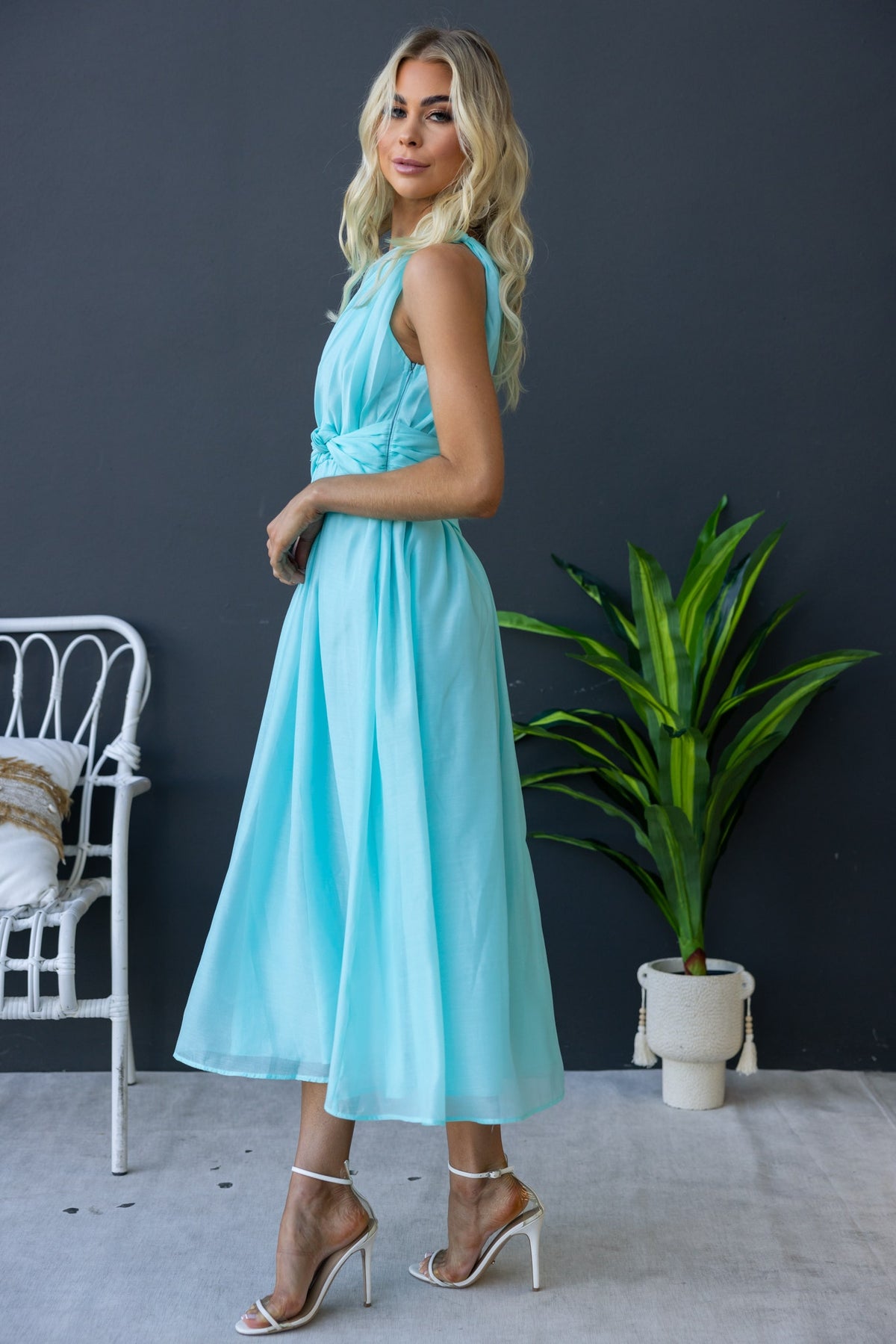 Model wearing Arturo Midi Dress in light blue, showcasing one-shoulder style and front knot detail.