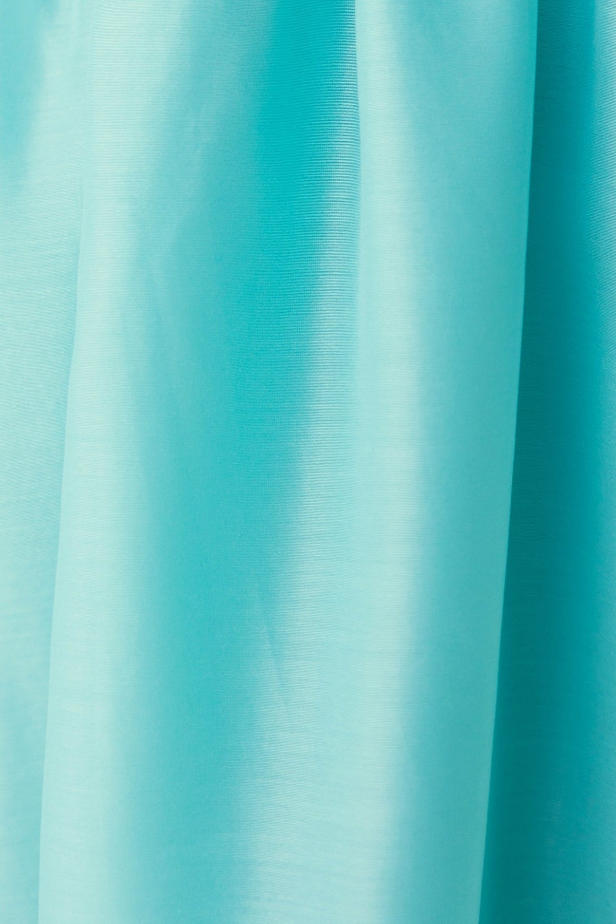 Close-up of soft aqua chiffon fabric, highlighting its smooth texture and vibrant color.