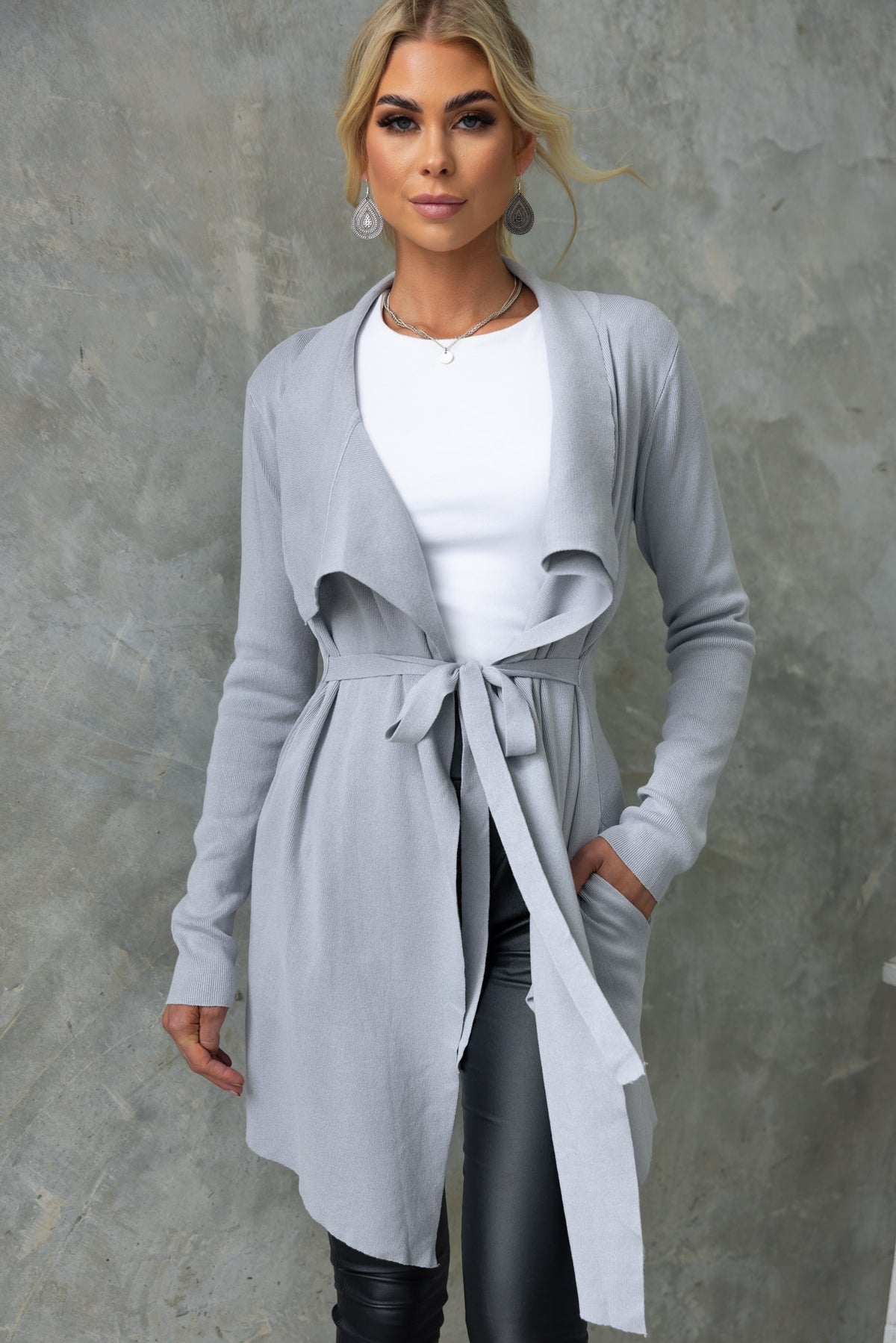 Stylish gray Acaia cardigan with lapel collar, attached belt, and pockets, perfect for a relaxed fit.
