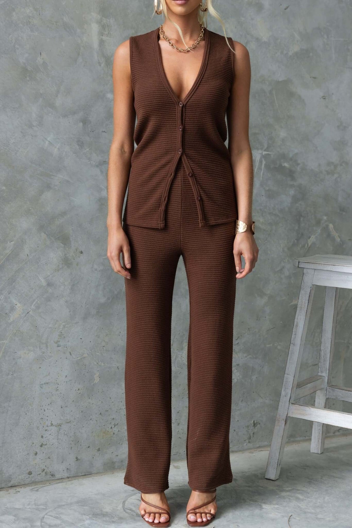 Xandra Top in brown knit fabric with V-neckline and button-up front, styled with matching pants.