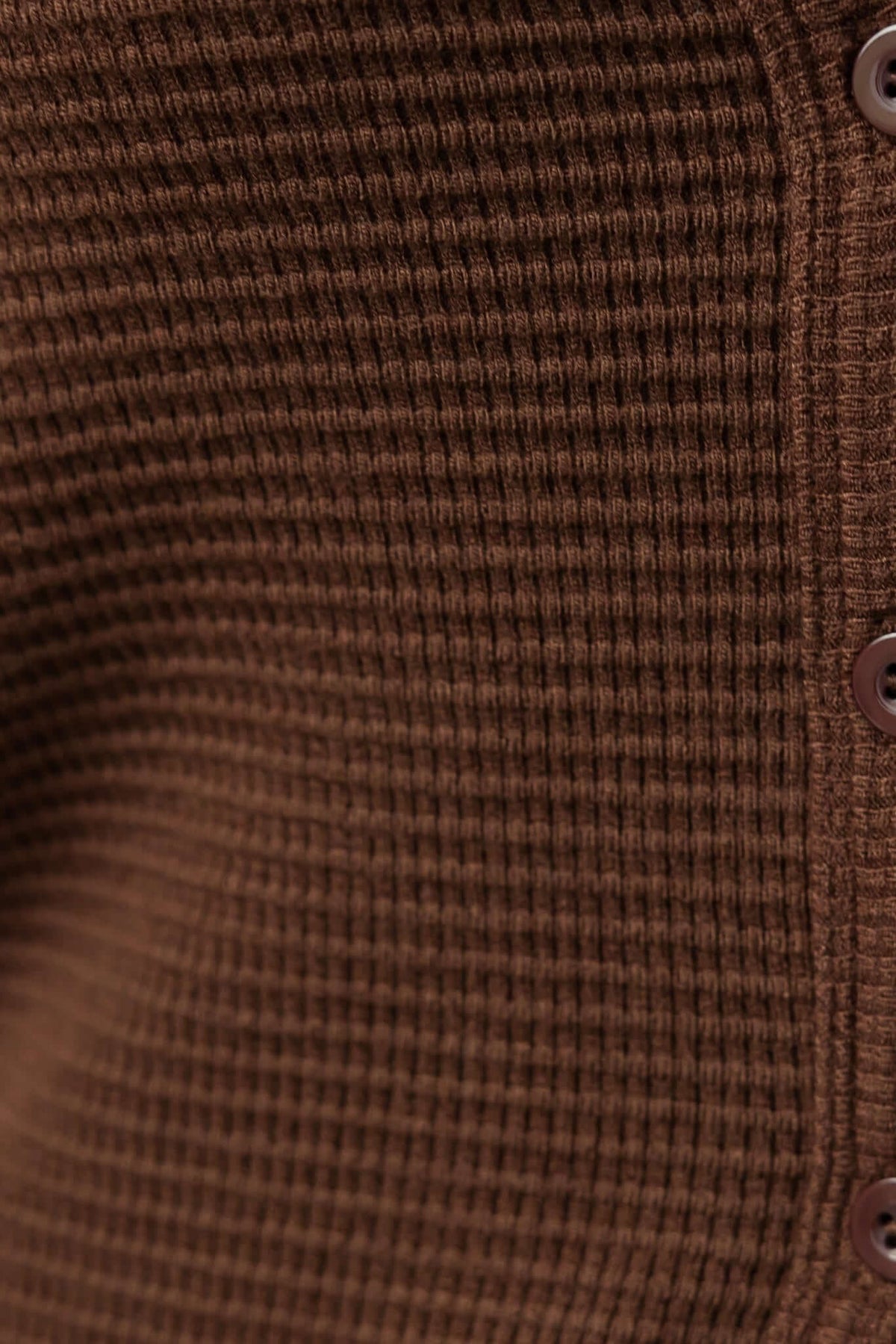 Close-up of Xandra Top, featuring textured knit material and button front in rich brown color.