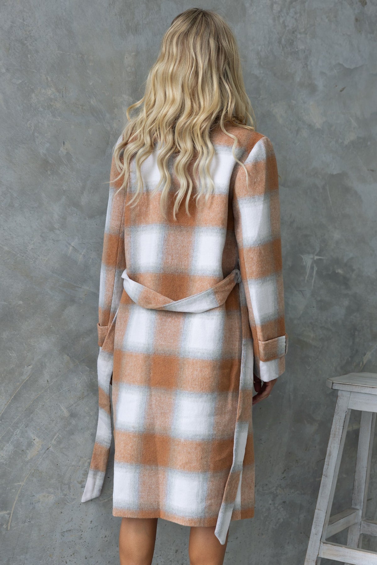 Back view of Amalie Coat featuring a plaid design, longline fit, removable tie, and pockets.