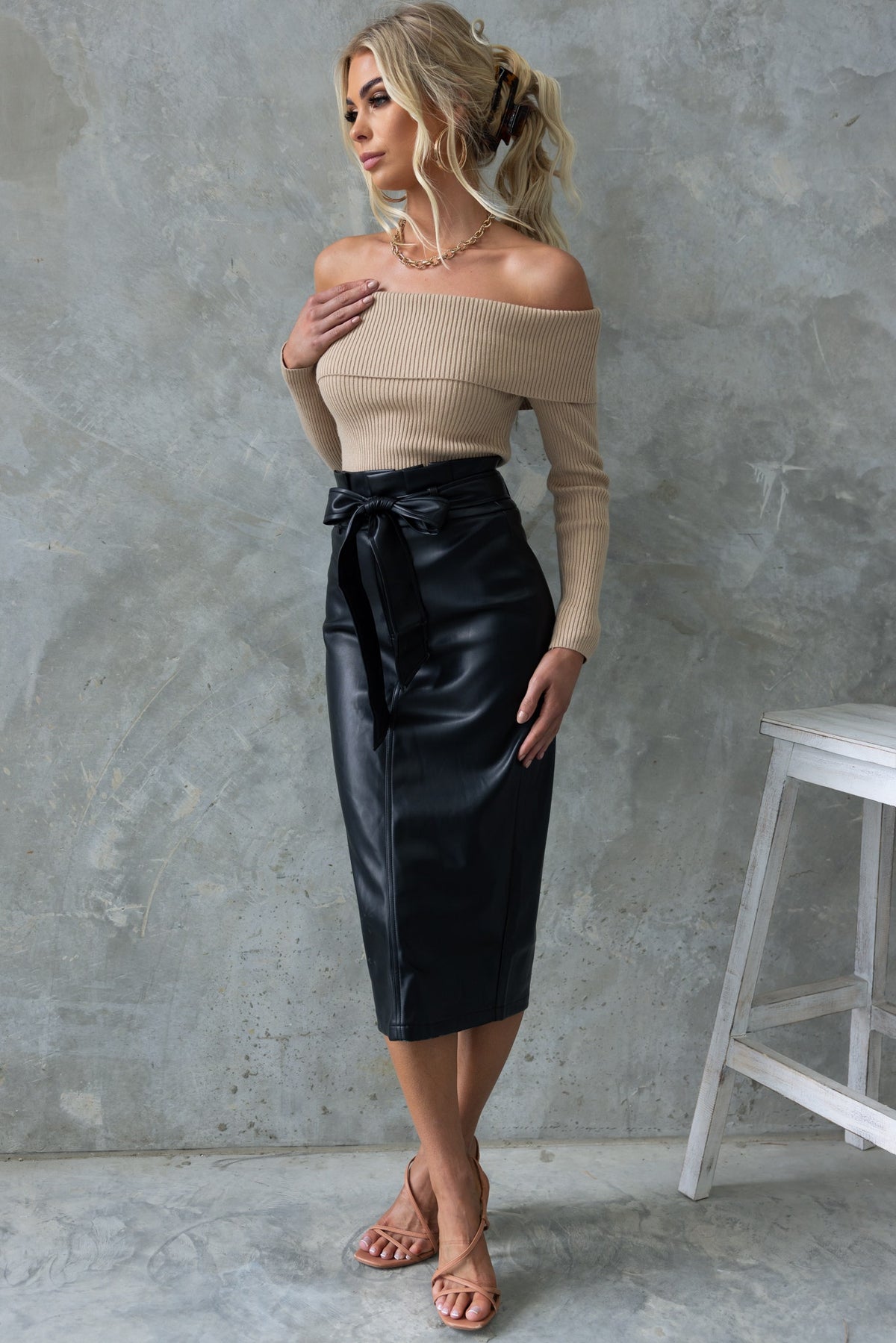 Nerida Midi Skirt in black faux leather with removable tie, mid-high waist, and sophisticated back split.