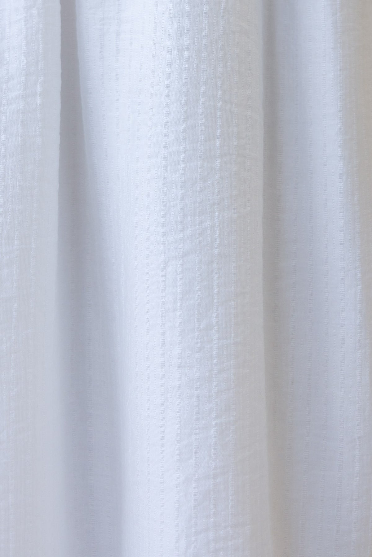 Textured white fabric of the Shanina Midi Dress, showcasing its lightweight and airy material.