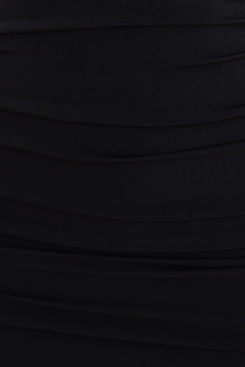 Black bodycon dress with ruching details and stretchy fabric, showcasing a smooth, elegant silhouette.