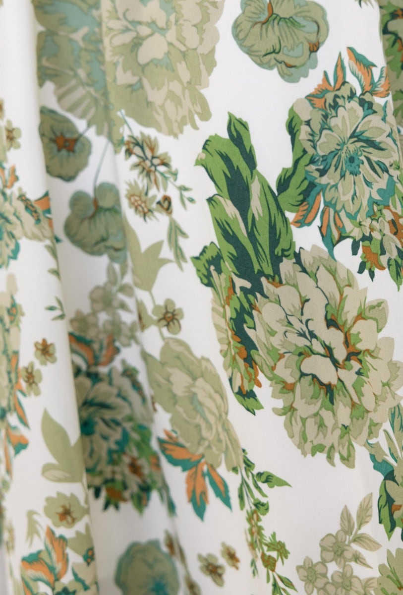 Close-up of floral print in green and cream on Corria Midi Dress, showcasing intricate blooming patterns.