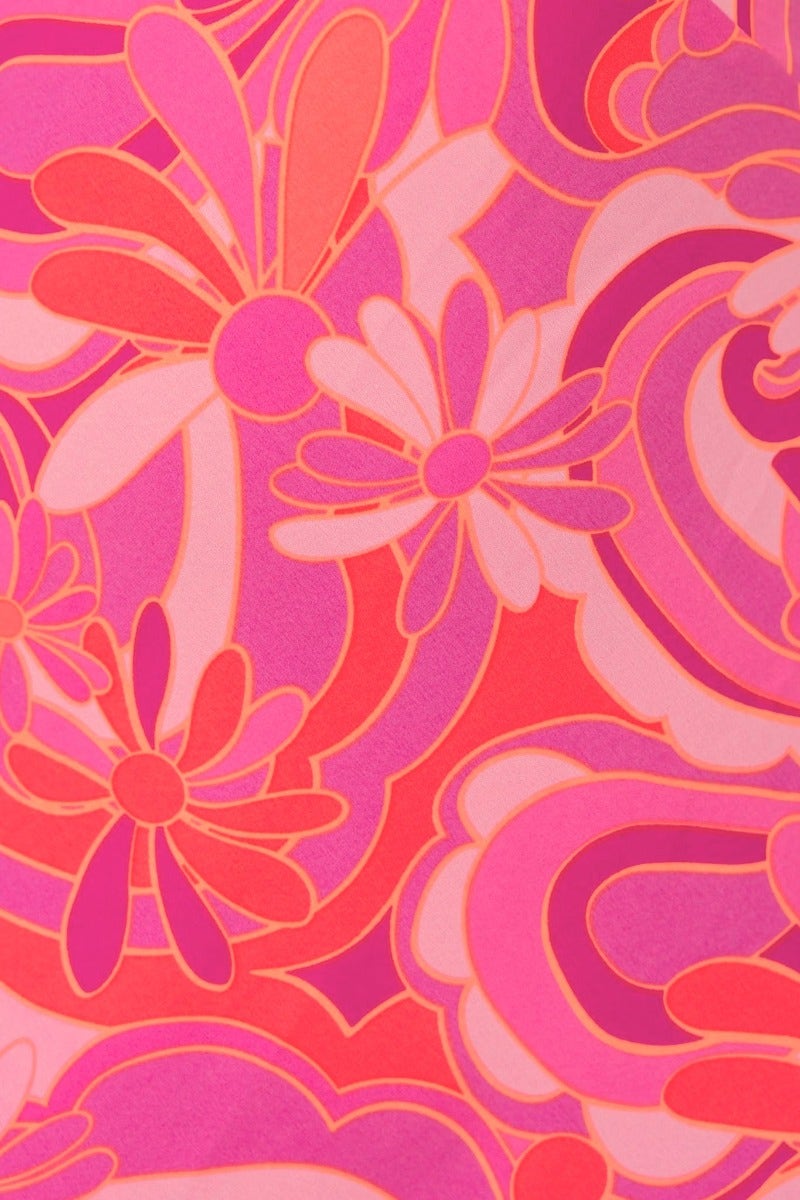 Bright floral print design in pink and coral, featuring oversized flowers on a vibrant background.