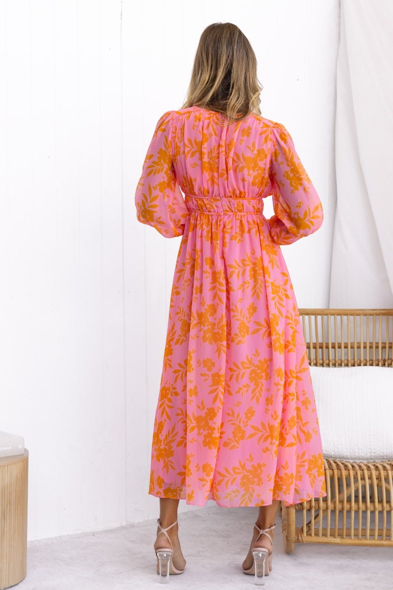 Back view of the Jeanie Maxi Dress featuring a floral print in pink and orange, perfect for summer occasions.