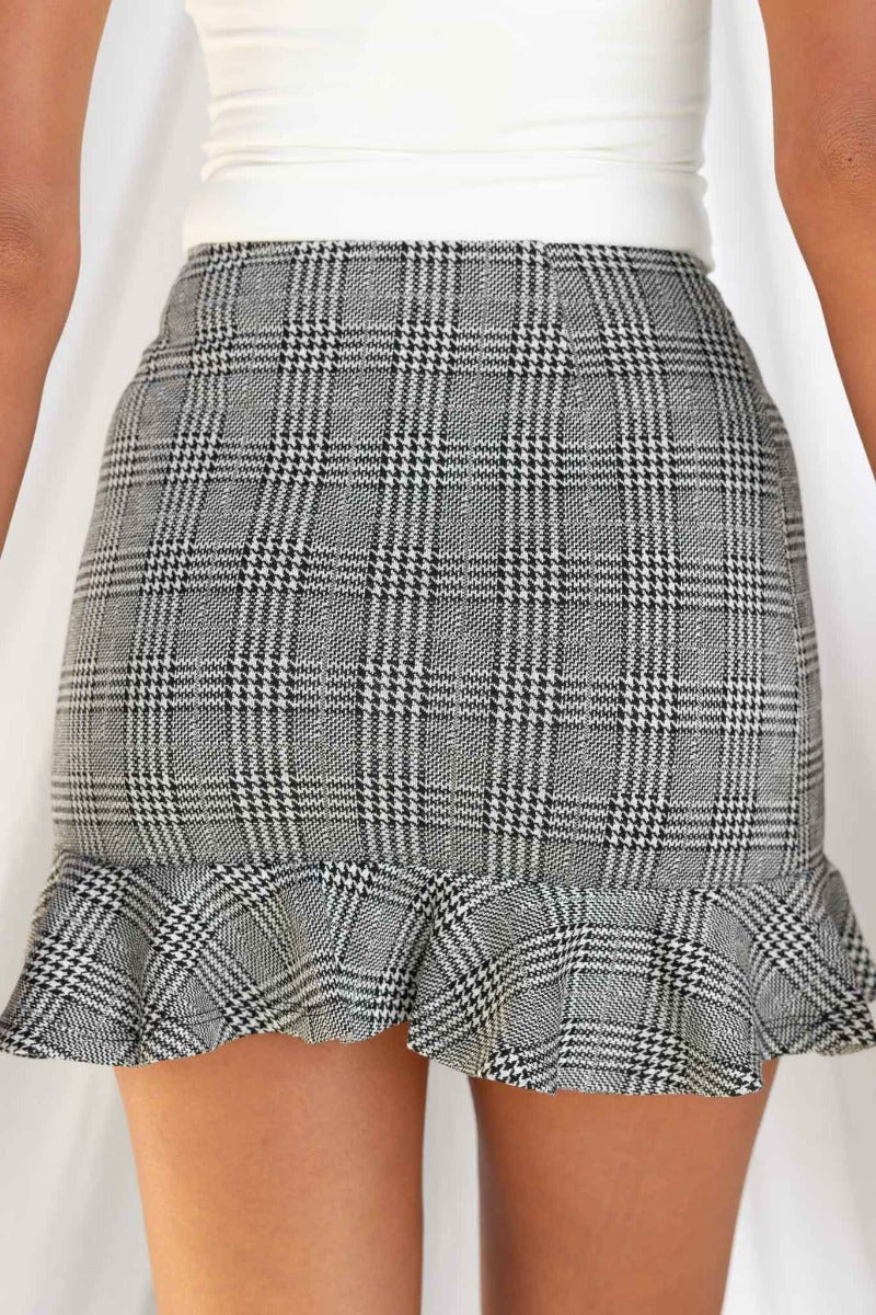 Thelma Skirt: Houndstooth pattern with ruffle hem, side invisible zip, standard fit, made from 100% stretchy polyester.
