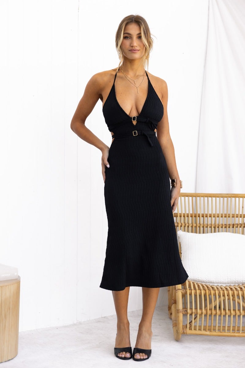 Black textured midi dress with adjustable halter neckline and buckle detail, showcasing a stylish fit.