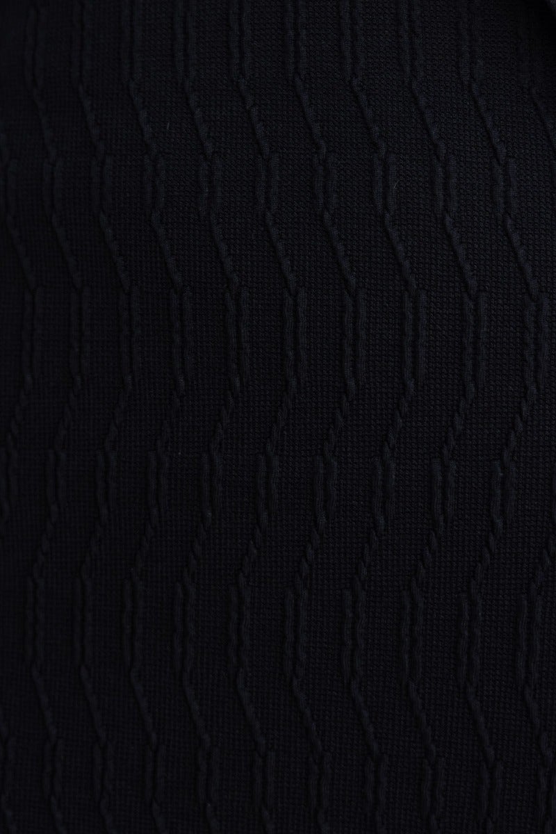 Close-up view of the black textured fabric of the Eyona Midi Dress featuring wavy pattern.