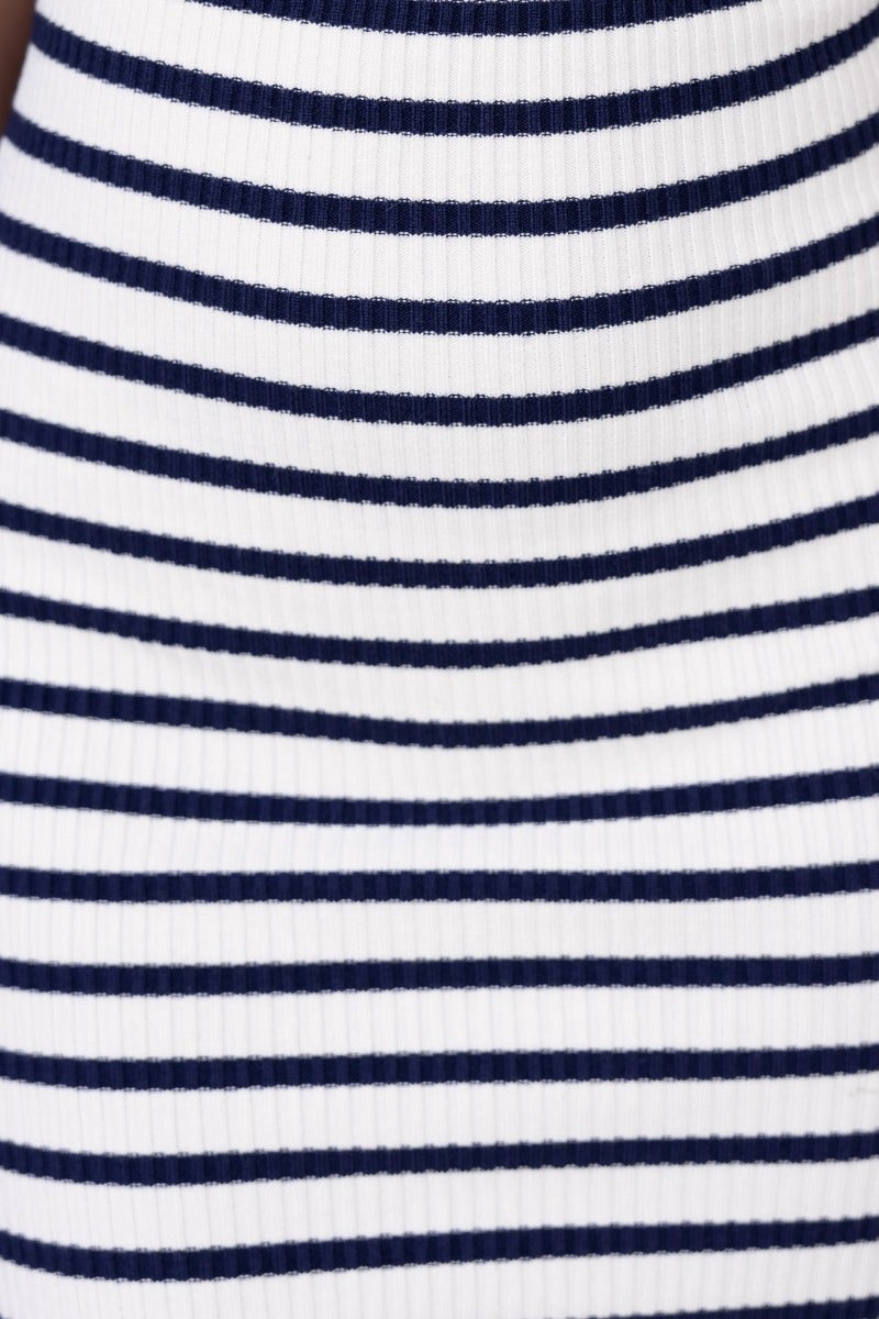 Close-up of navy and white striped ribbed knit fabric for the Camino Midi Dress, showcasing its texture and pattern.