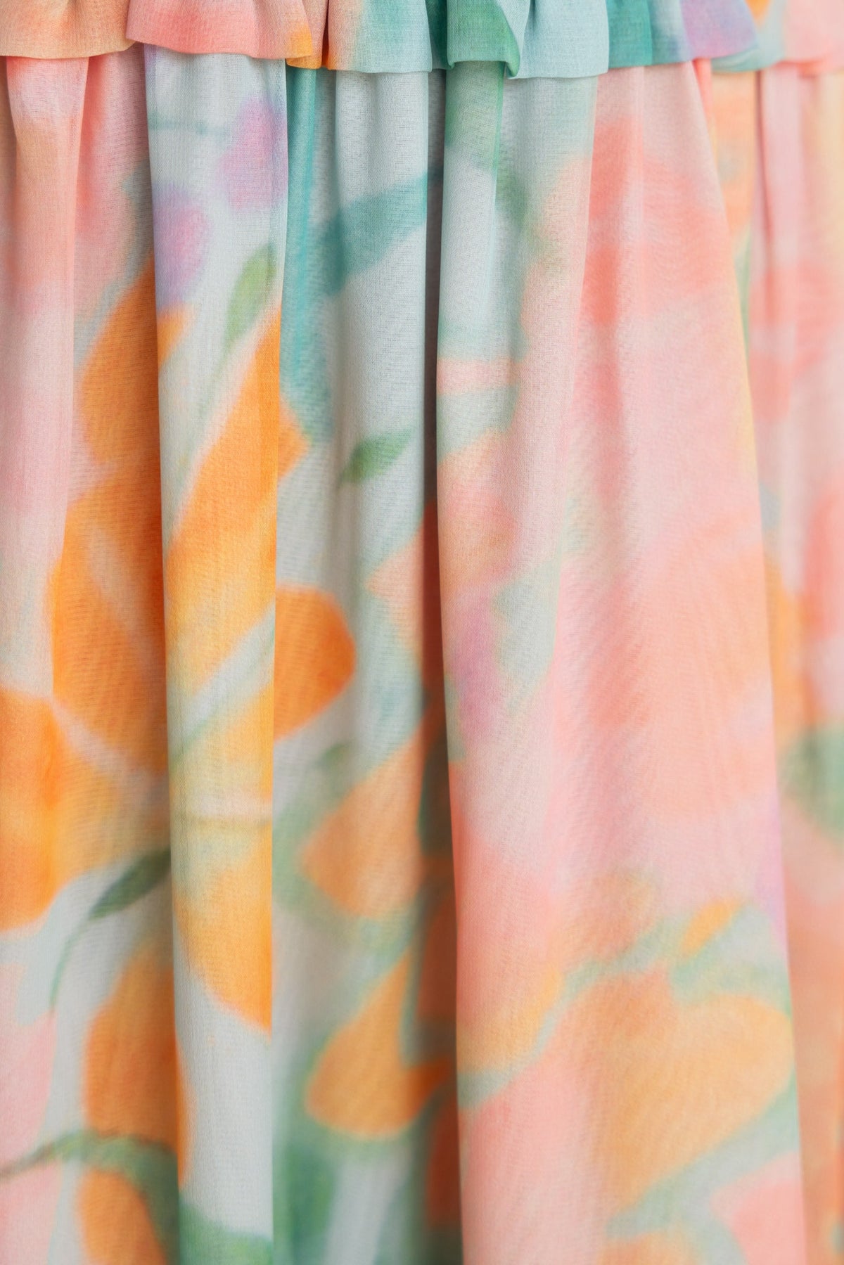 Close-up of floral print chiffon fabric in pastel colors for Alara Maxi Dress, showcasing intricate details and textures.
