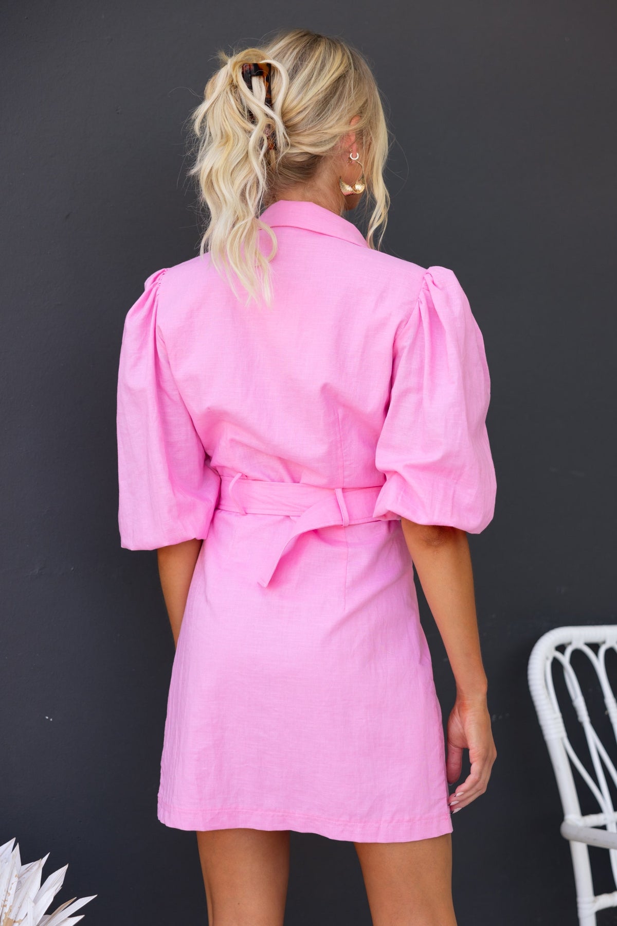 Back view of a pink Astyn Dress with puff sleeves and removable belt, featuring a stylish collar and casual fit.