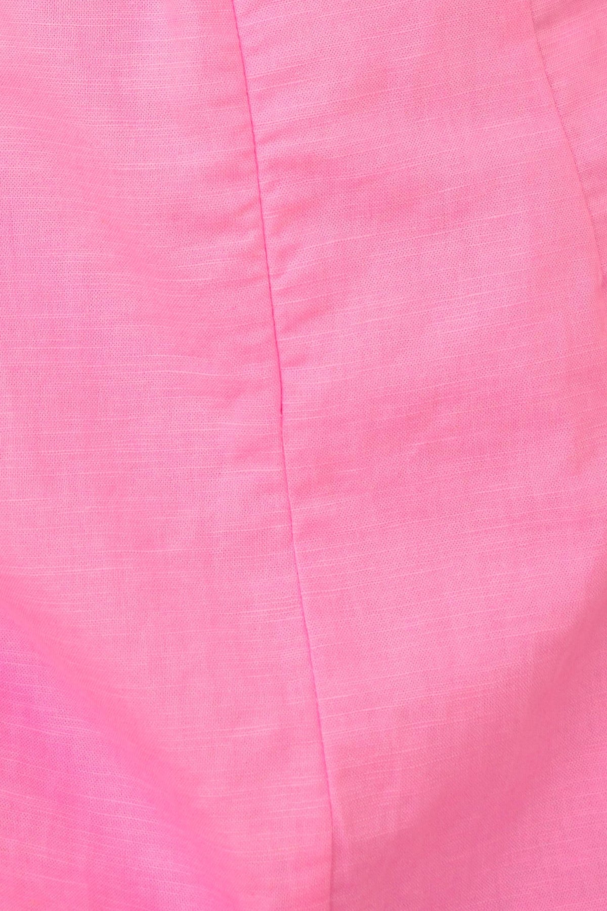 Close-up of pink fabric texture, showcasing soft cotton feel, perfect for stylish dress designs.