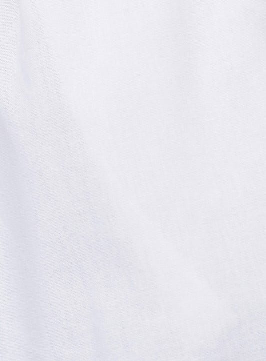 Close-up of soft white linen blend fabric showcasing a smooth texture, ideal for Tiann shorts.
