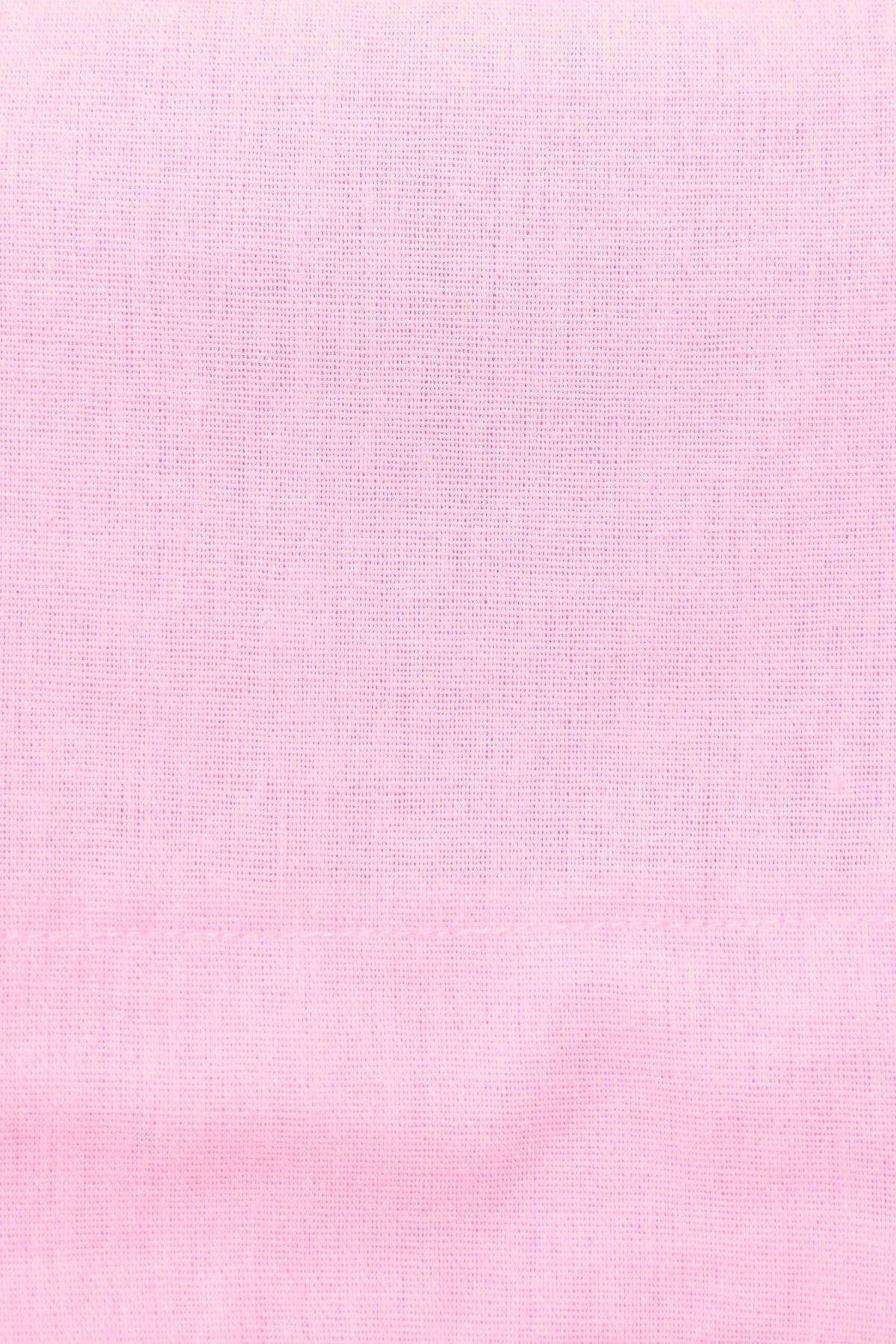 Close-up of soft pink linen fabric with a subtle texture, perfect for the Tiann Top's stylish design.