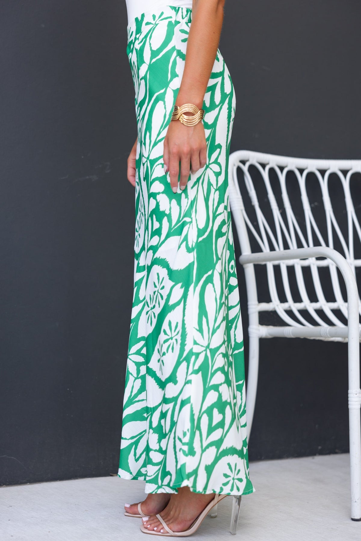 Side view of Sami Maxi Skirt with green floral print, showcasing mid-high waist fit and flowy design.