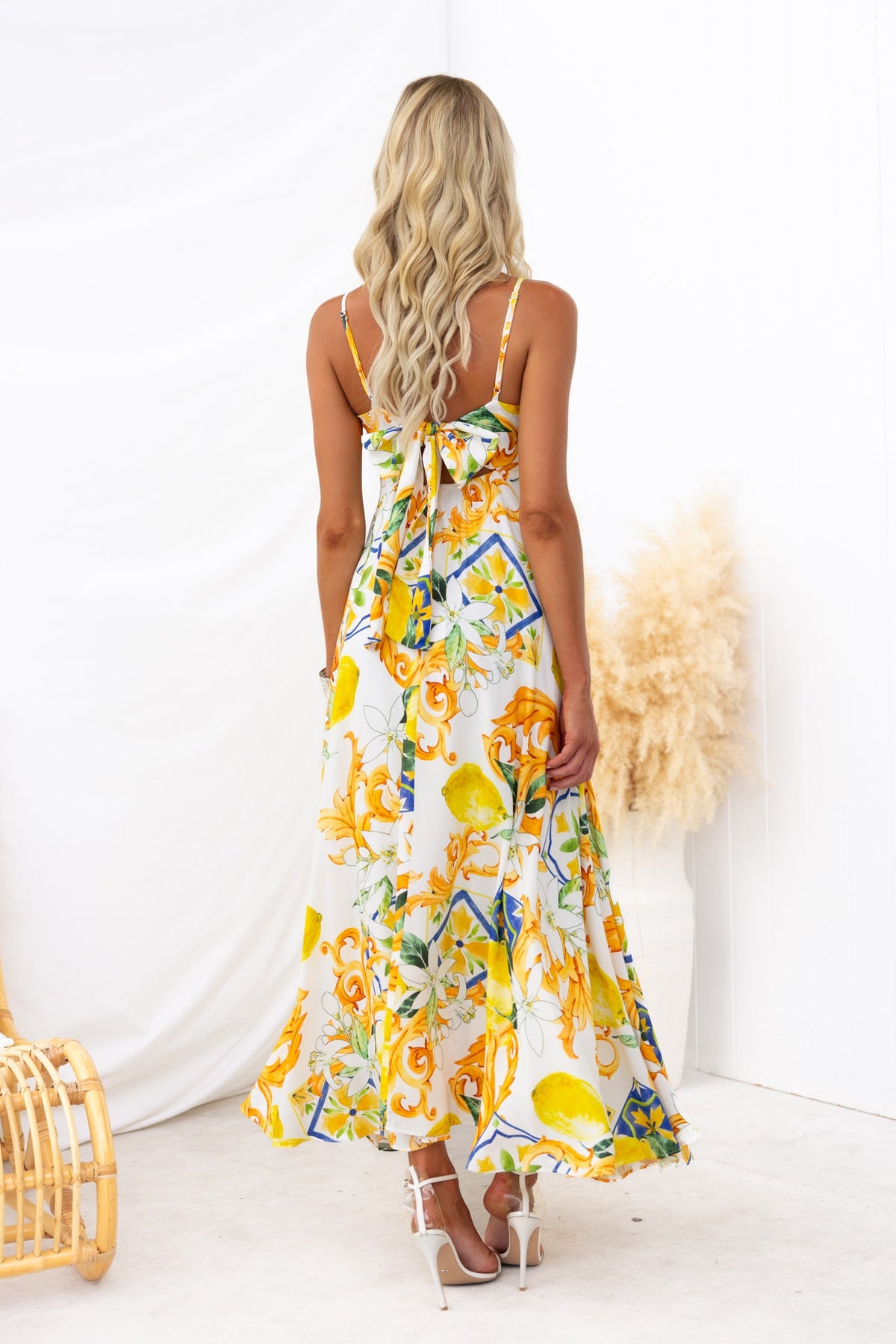 Back view of a Summer Crush Maxi Dress with abstract floral print, adjustable straps, and a flowing design.