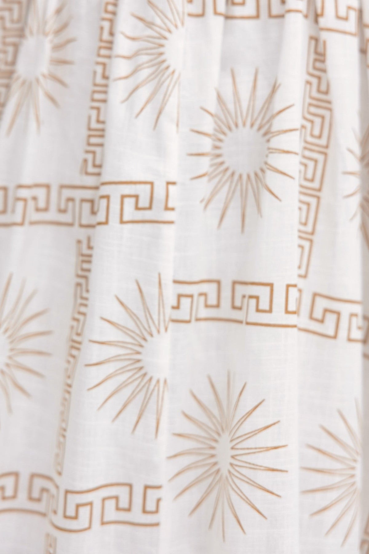 Close-up of abstract print featuring sunburst and geometric patterns on fabric for Bordeline Maxi Dress.