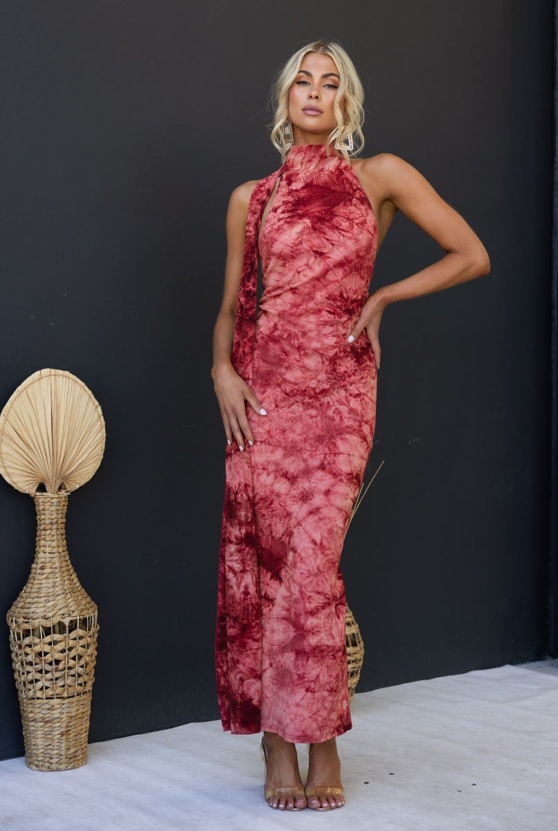 Model showcasing Eyona Maxi Dress in multi-colour with wrap detail and open back against a dark backdrop.
