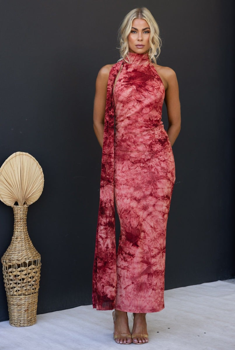 Multi-colour Eyona Maxi Dress with high neckline and wrap detail, featuring an open back and ruching, styled against a dark background.