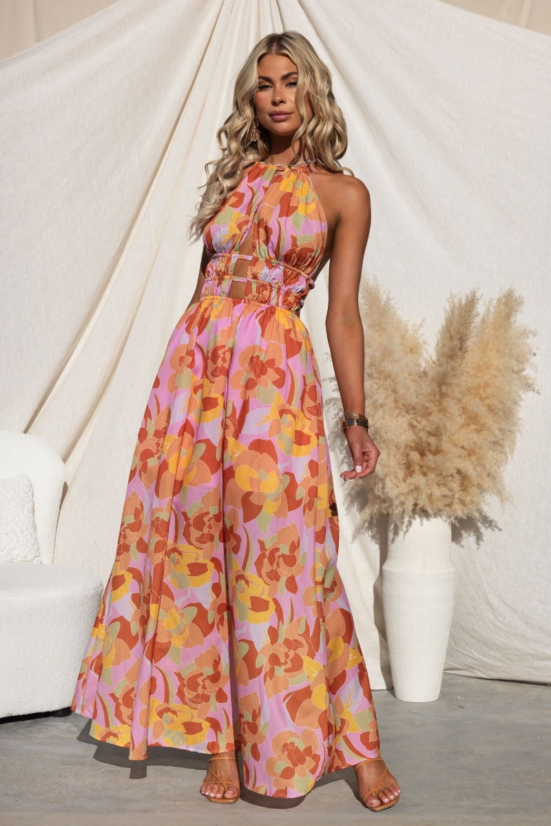 Kariah Maxi Dress featuring a colorful floral pattern, adjustable halter neck, elastic waistband, and back clasp closure.
