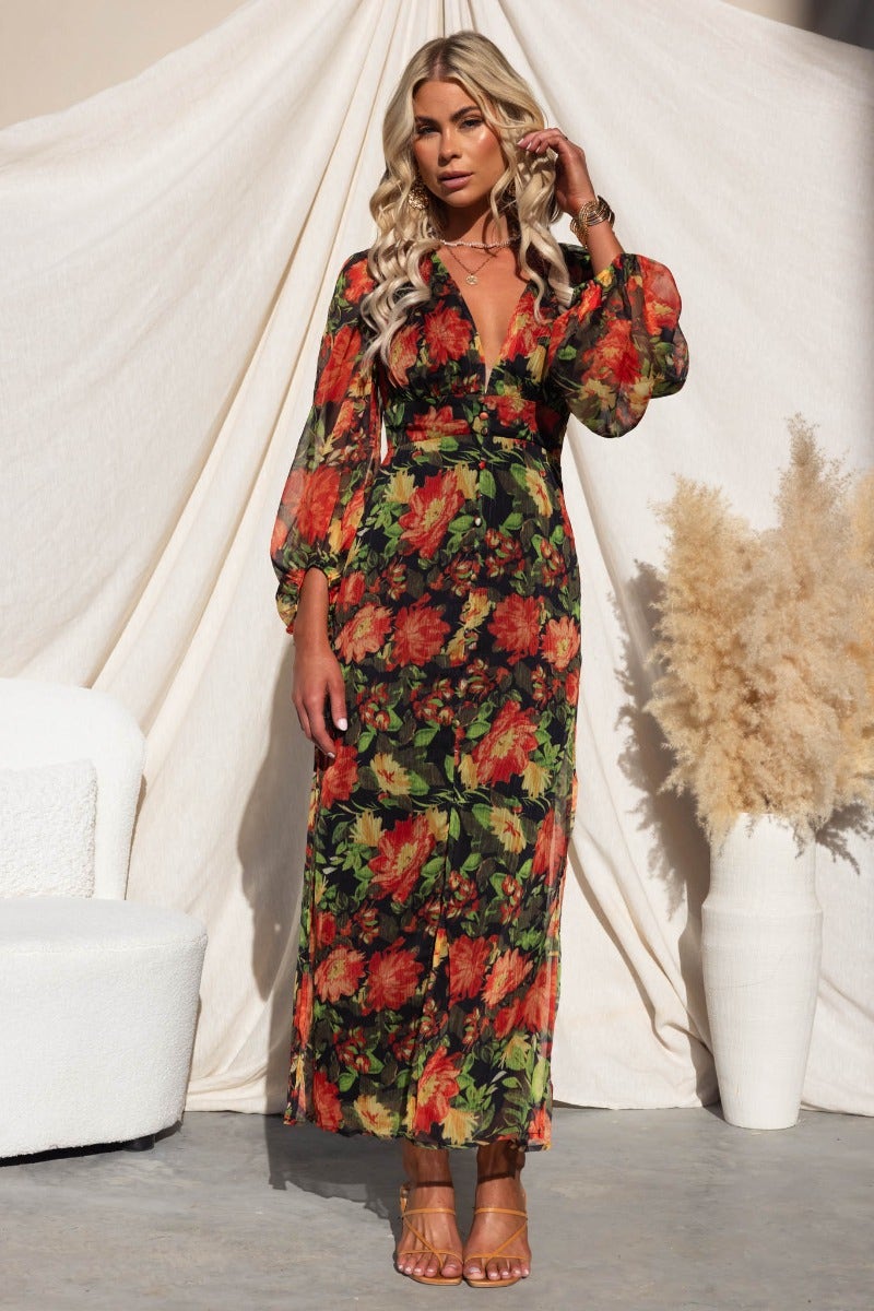 Mietta Maxi Dress: Black floral print dress with V-neck, faux buttons, and split at front, perfect for summer events.