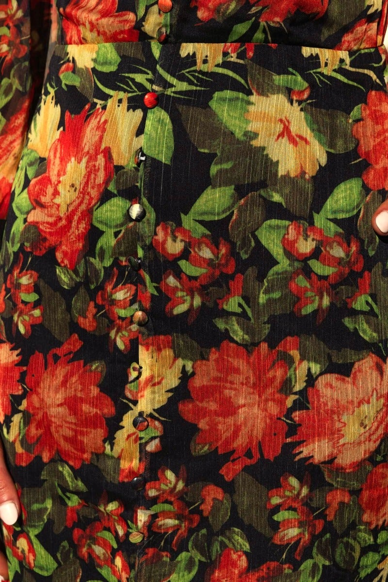 Close-up of the Mietta Maxi Dress showcasing the vibrant floral print and faux button-up details.