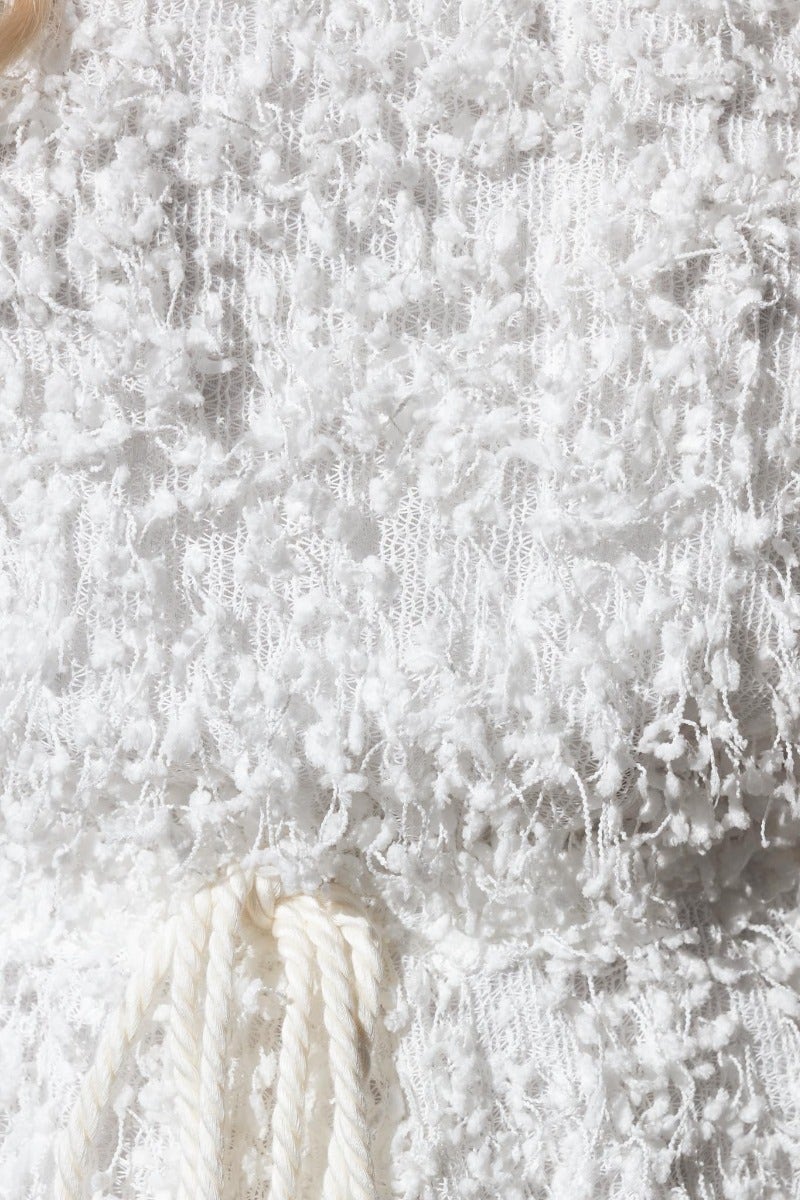 Close-up of textured white material of the Zoey Playsuit, featuring an adjustable drawstring and lined detail.