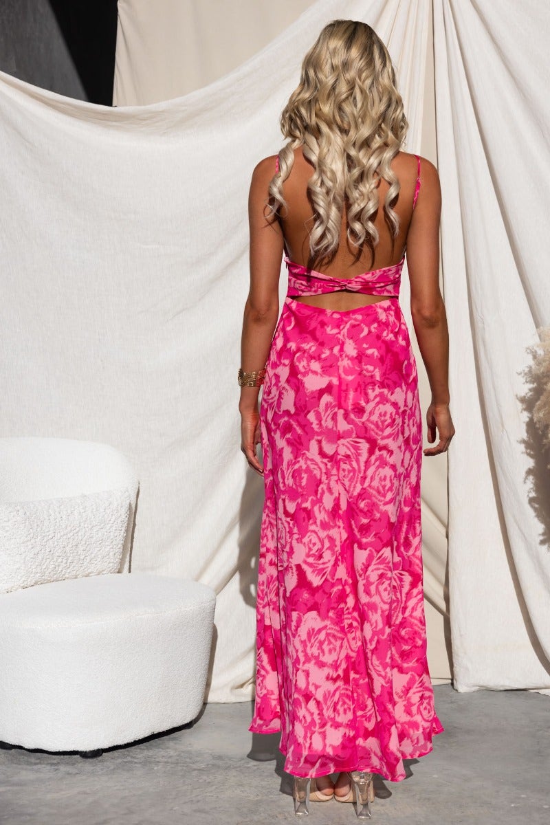 Back view of Freyda Maxi Dress in pink floral design with adjustable straps and cut-out back.