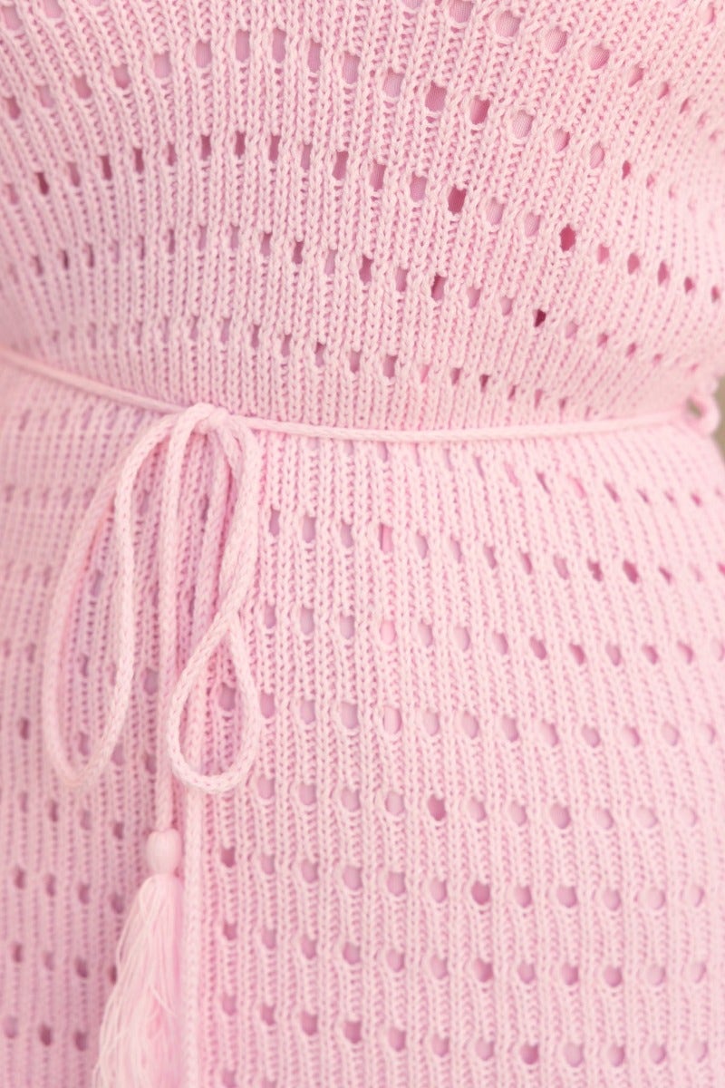 Close-up of the Jadell Dress showing the pink knit fabric, V-neckline, and removable tie detail.