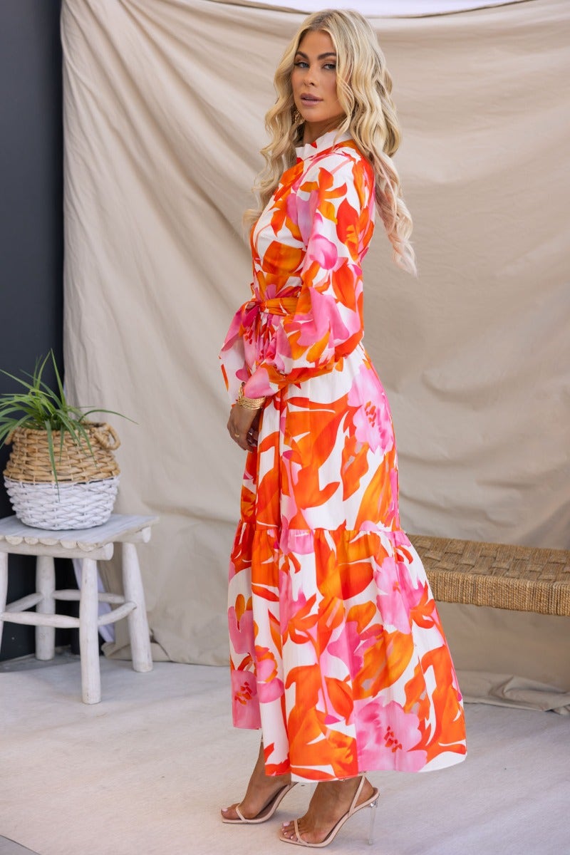 Ikoma Maxi Dress with floral print, high neckline and cut-out at bust, featuring a fabric tie and long sleeves.