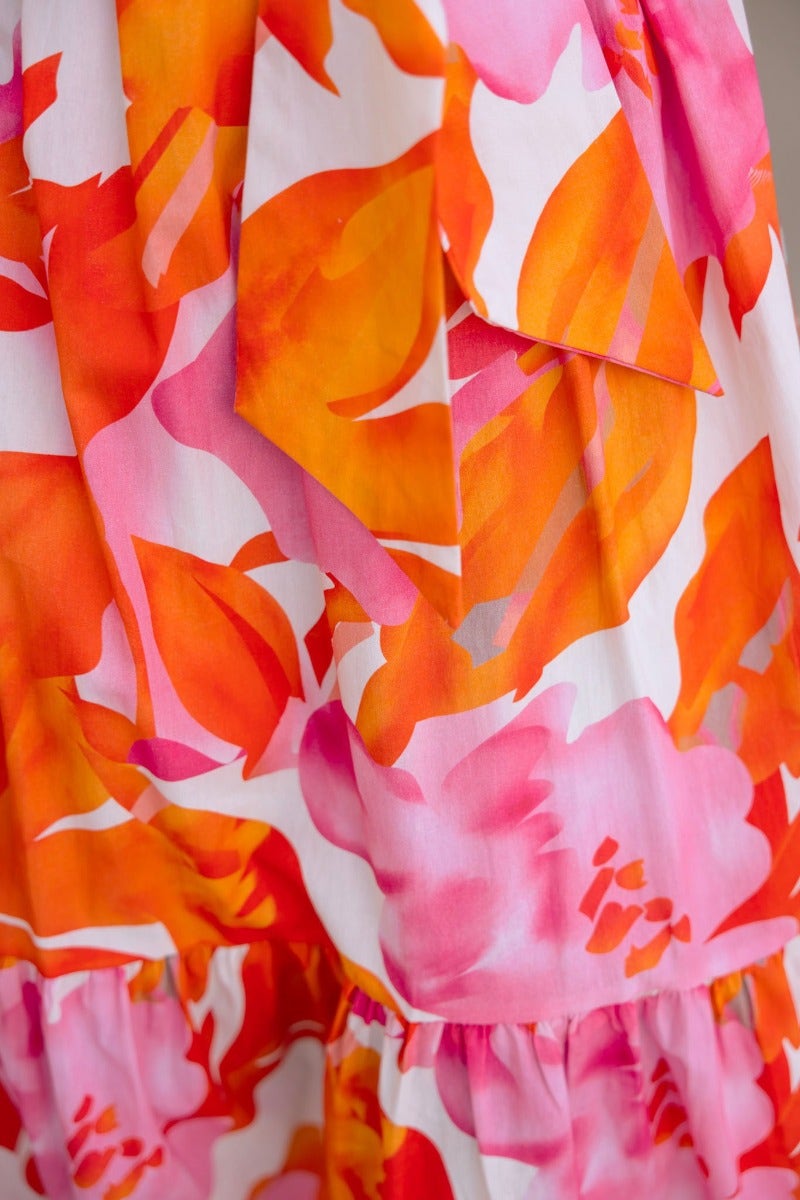 Close-up of floral print on Ikoma Maxi Dress featuring vibrant orange and pink flowers.
