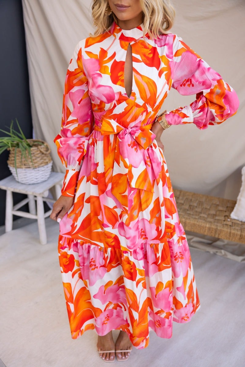 Ikoma Maxi Dress with floral print, high neckline, cut-out bust, and removable tie, perfect for a stylish summer look.