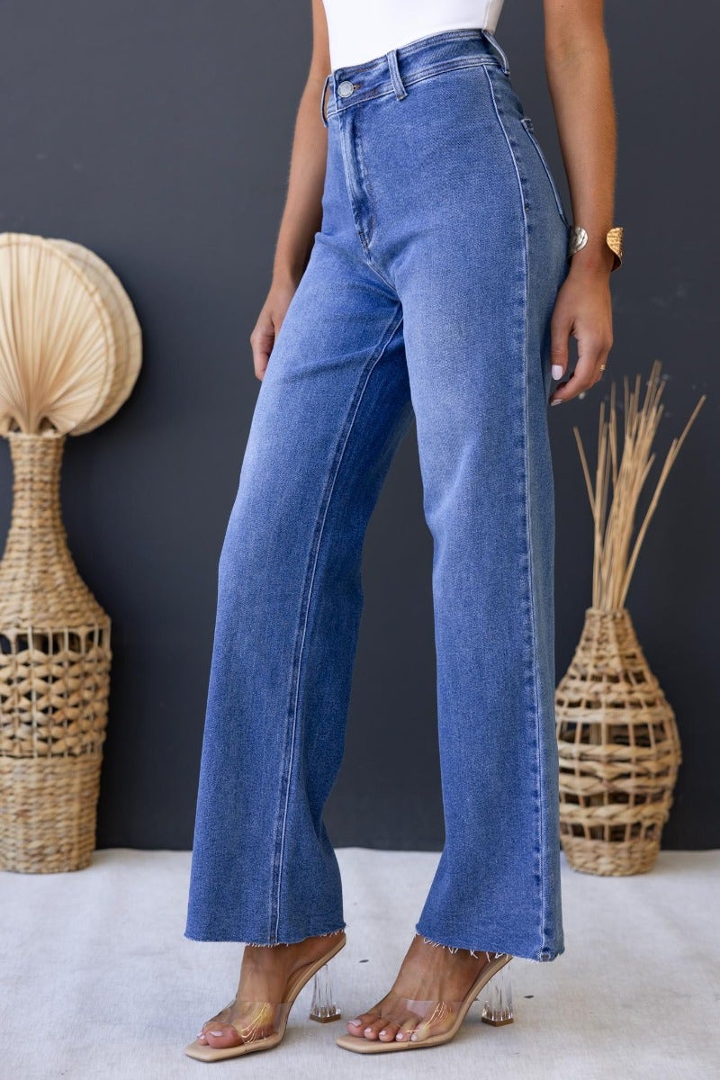 Timberlake Jeans with mid-high waist and wide legs, styled with a casual top, showcasing denim stretch and back pockets.