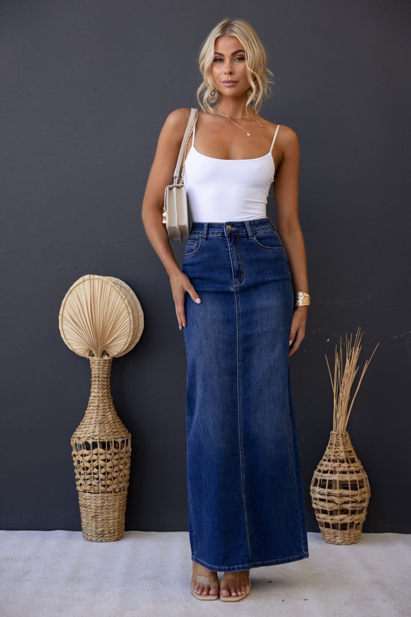 Model wearing Xano Denim Maxi Skirt with a mid-high waist and pockets, styled with a fitted top