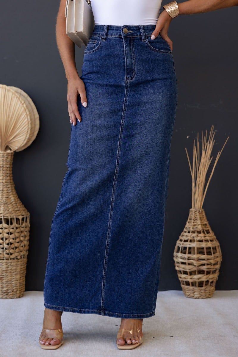 Xano Denim Maxi Skirt in blue with mid-high waist, front and back pockets, model wearing size 6/XS.
