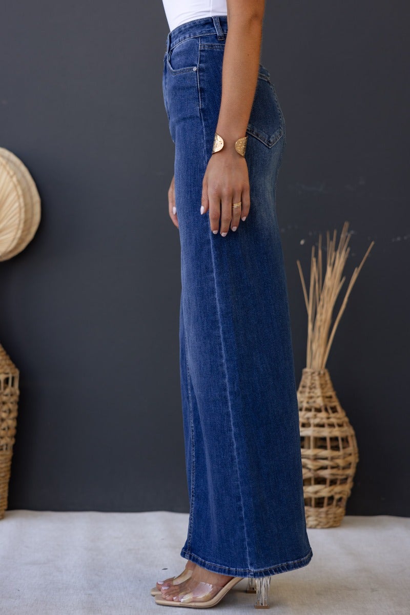 Side view of Xano Denim Maxi Skirt with mid-high waist fit, featuring pockets and a relaxed flow.