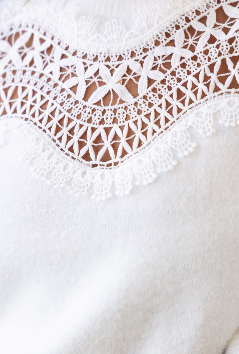 Close-up of Kyoto Jumper featuring intricate lace detail at the bust, showcasing its knit texture and high neckline.