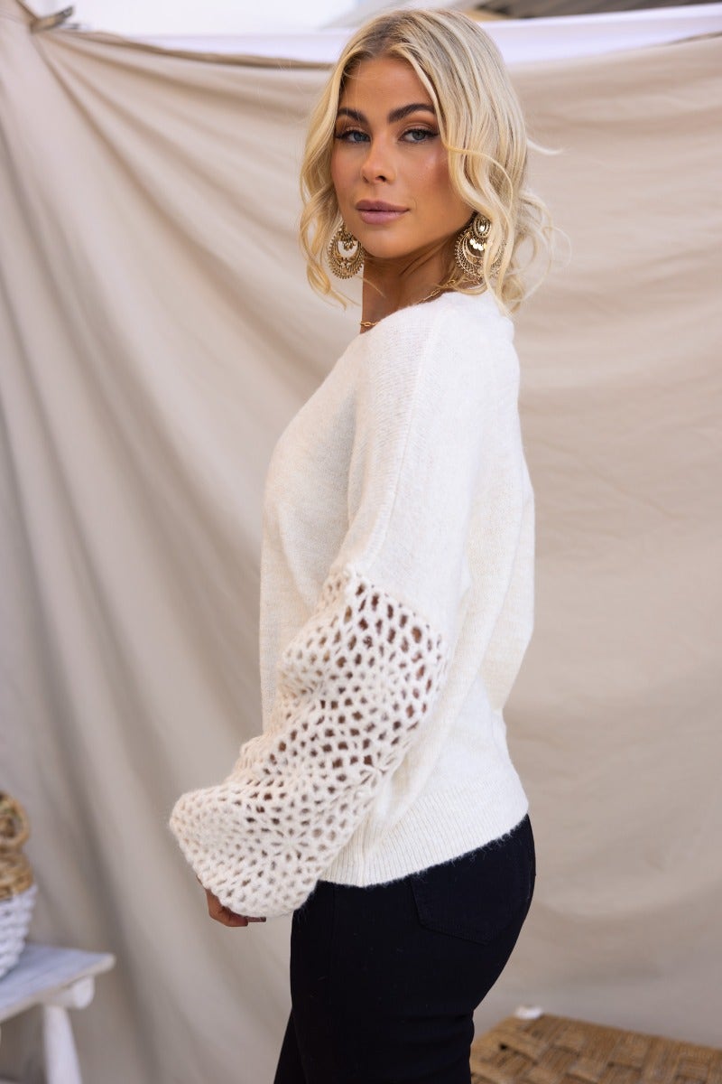Elegant Keilor Jumper featuring a round neckline and open weave knit detail at sleeves, styled in cream color.